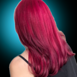 Back view of medium-length straight hair with long layers dyed in a bright cherry red and fuchsia tone.