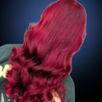 Rear view of long, flowing wavy hair dyed a vibrant magenta pink and deep ruby red color.